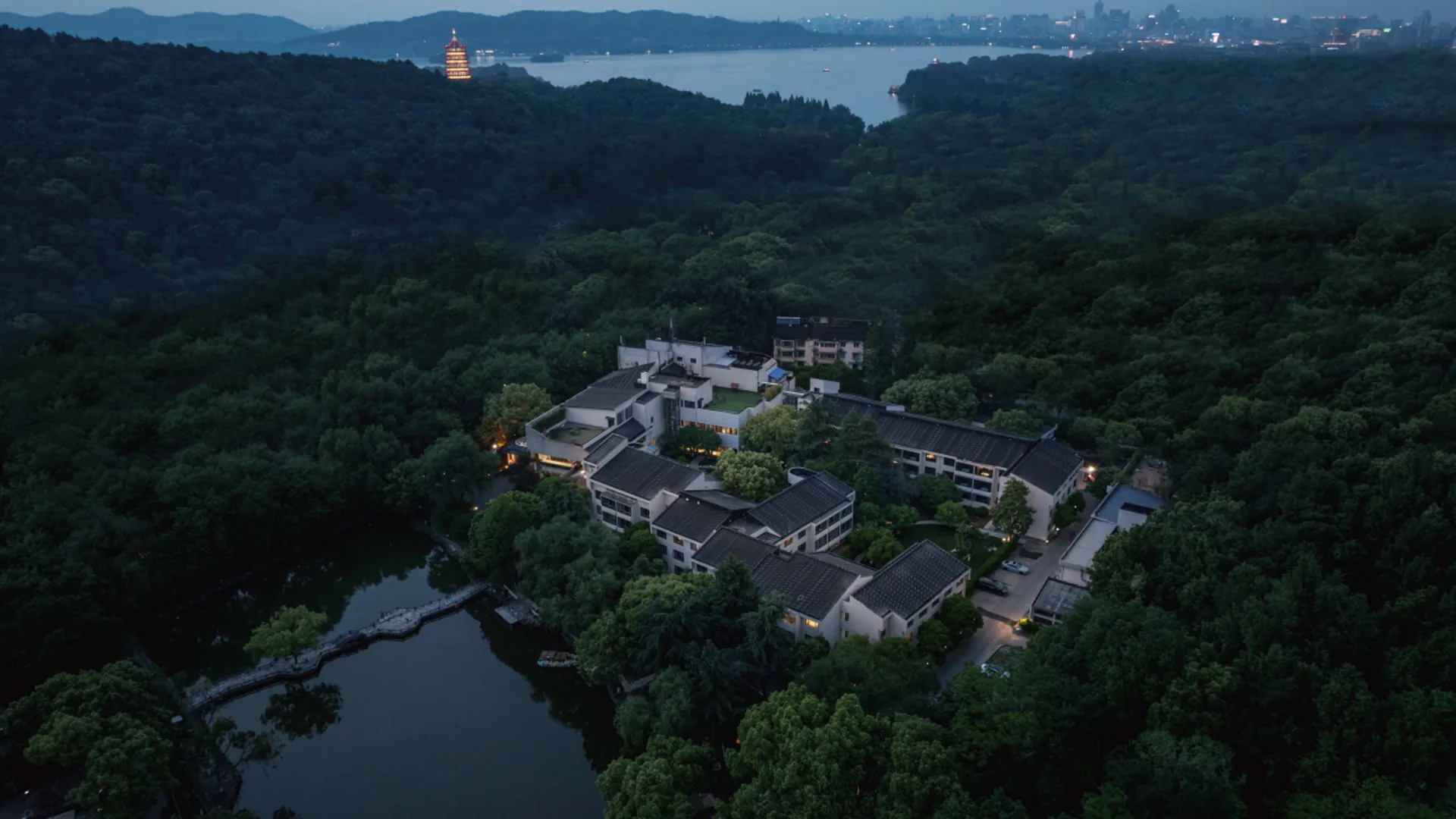 Aerial view of the Jade Emperor Hotel conference venue beside West Lake at dusk